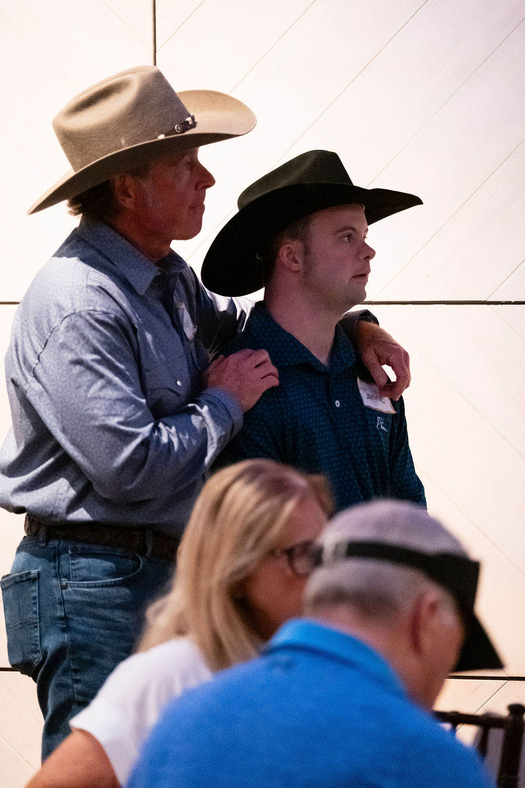 Two guests in cowboy hats at the Friday night dinner and auction at Blue Mesa