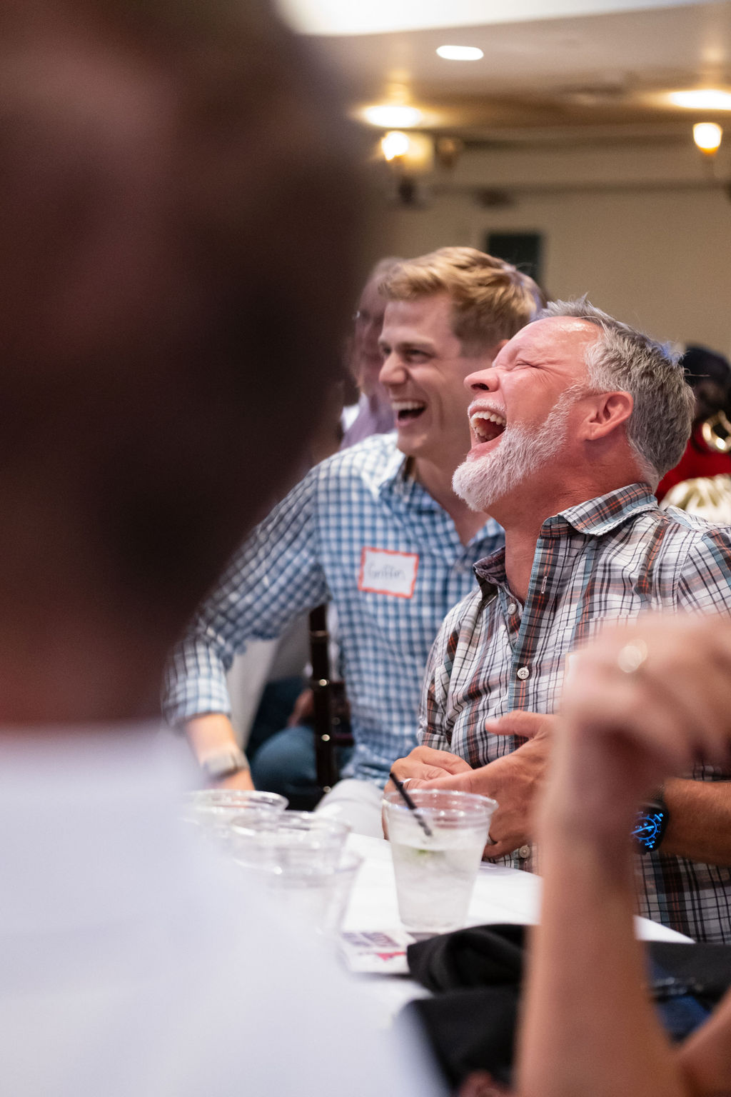 Guests laughing during the live auction