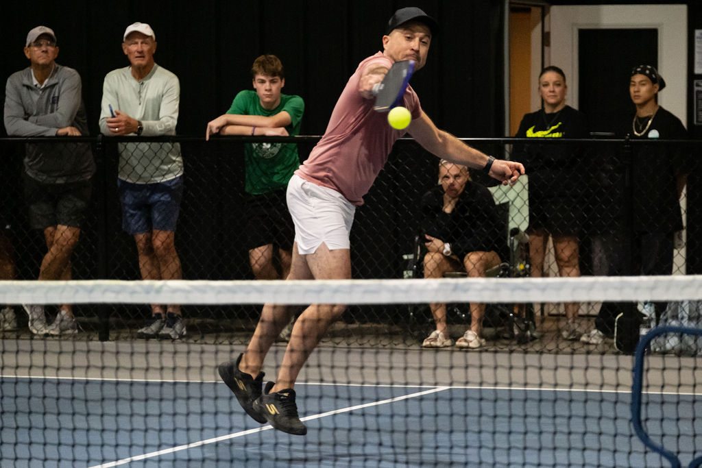 A player leaps for a ball at the net