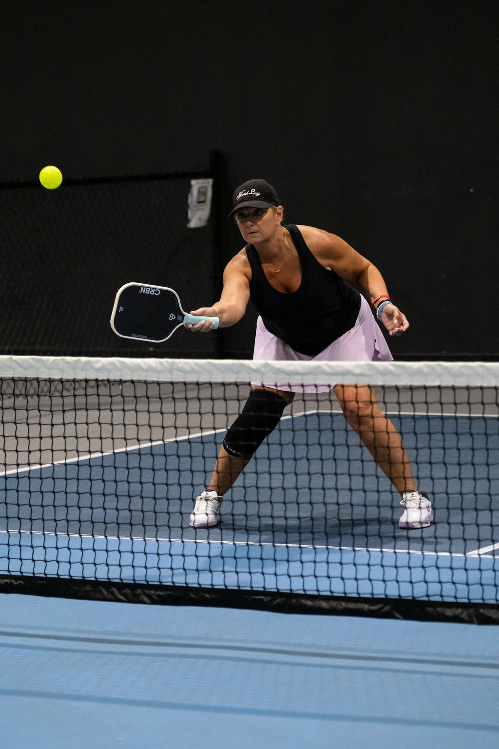 A player prepares a dink at the net