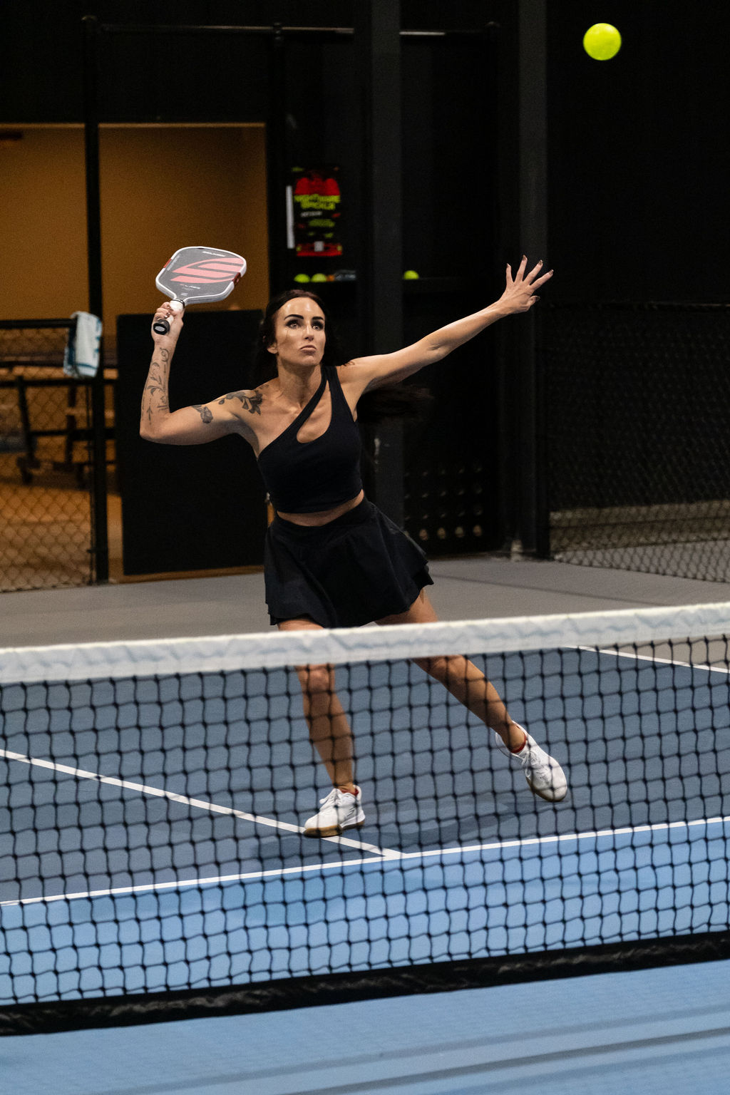 A player lines up an overhead at the net