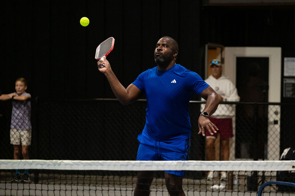 A player resets a ball off the net