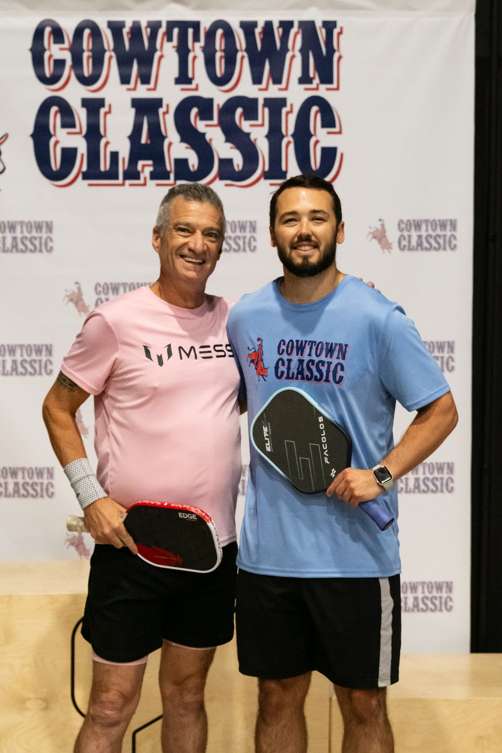 A Pro-Am team poses with their paddles